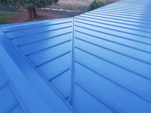 Blue standing seam metal roof installation in Medford OR – RP Construction Management