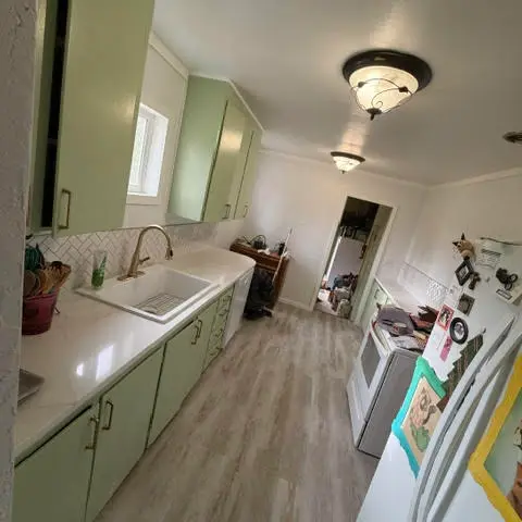 Kitchen renovation with sage green cabinets and new flooring near Ashland OR – RP Construction Management